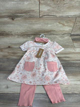 Floral baby dress with pink pockets, matching pink leggings, and headband on wooden floor
