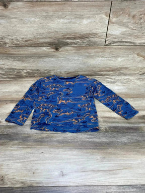 Flat lay of toddler long-sleeve blue dino shirt size 4T with orange dinosaur print and chest pocket on wood background