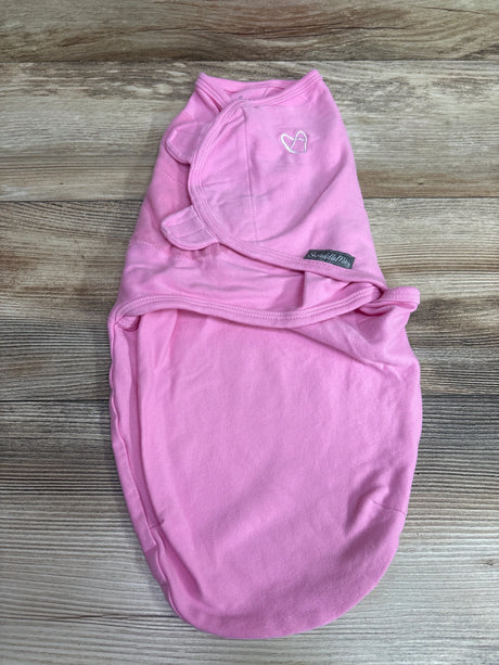 Pink SwaddleMe swaddle wrap for infants size 0-3m on a wooden background