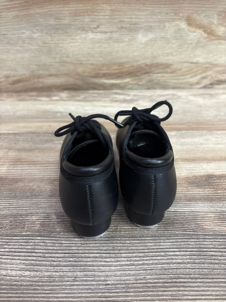 Rear view of Theatricals Footwear black lace-up tap shoes, size 9.5C, showing tied laces and heel taps on a wood-look floor