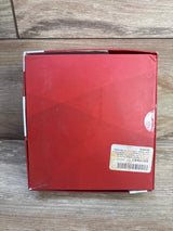 Top-down view of Skyfield 4pk wooden animal puzzles box showing red cardboard packaging and a peeling shipping sticker on a wood surface