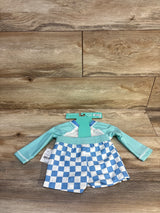 Toddler swim set with aqua long sleeve rash guard and blue checkered swim shorts on wood floor