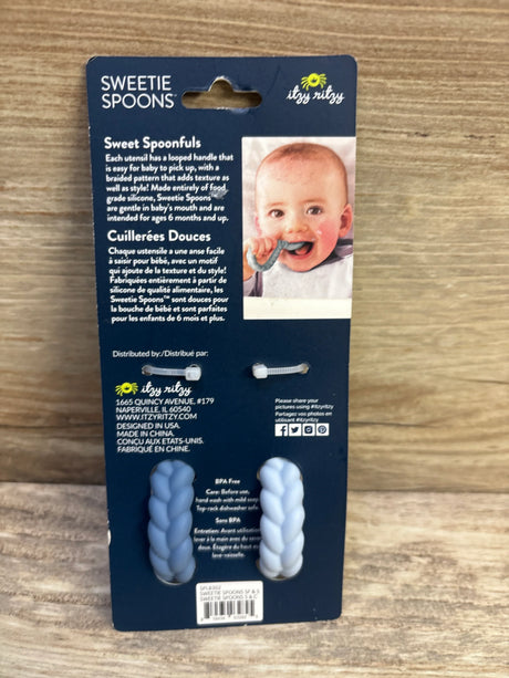 Front view of Itzy Ritzy Sweetie Spoons set in blue showcasing two braided-loop silicone utensils on a navy backing card with baby photo