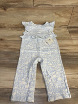 Light blue baby romper with white floral print, ruffle sleeves, and snap closures