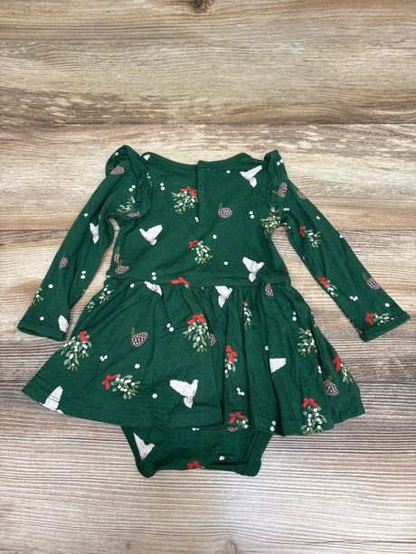 Front view of green Kyte Baby Bamboo Mistletoe Twirl Bodysuit Dress showcasing long sleeves and twirl skirt on wood