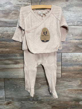 Front view of beige Rabbit and Bear kimono shirt and footed pants on hanger showing side snap and ribbed organic knit on wood