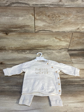 Front flat lay of taupe H&M 3pc baby shirt set size 3M showing long-sleeve top with side snap buttons and 'hello world' text, with striped pants on wood floor