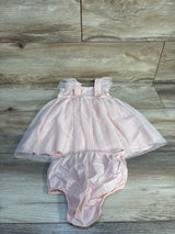 Light pink baby girl dress with ruffle sleeves and matching diaper cover on wood background