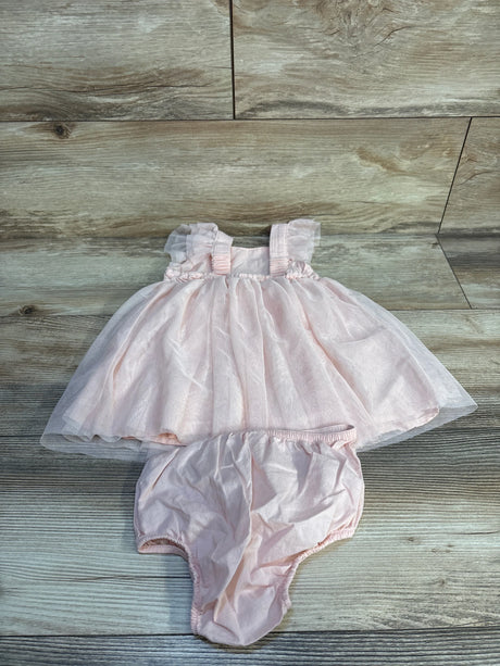 Light pink baby girl dress with ruffle sleeves and matching diaper cover on wood background