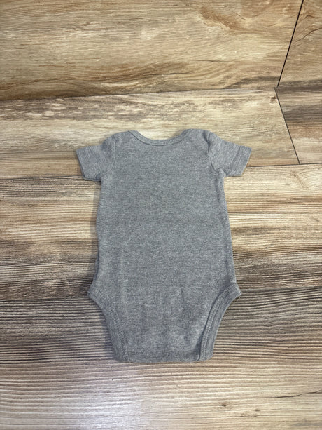 Flat-lay back view of grey Wiracle Wear baby bodysuit, short sleeves, heather knit fabric, size 3-6 months on wood background