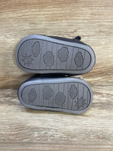 Bottom view of navy Just One You Harrison fisherman sandals size 4/5C showing cloud and sun tread on wooden surface