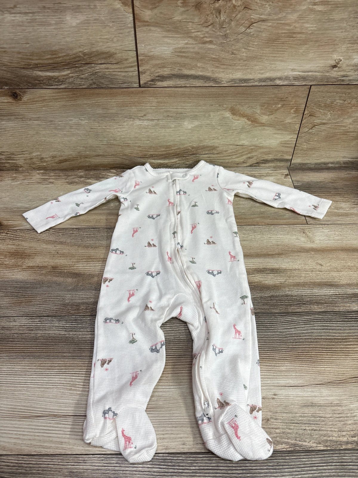 Front view of ivory Just One You waffle knit sleeper with long sleeves, footed legs, animal print, and front zipper
