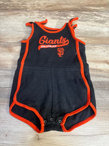 Black and orange San Francisco Giants baby romper with snap closures, on wood background