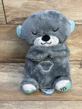 Gray plush bear stuffed animal with closed eyes, soft texture, embroidered details