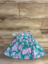 Flat lay of Cat and Jack teal sleeveless floral dress with matching bloomers showing pink flower print on wood floor
