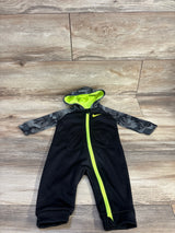 Top-down view of black Nike Dri-Fit hooded coverall with gray camo sleeves, neon yellow zipper and hood lining on wood floor