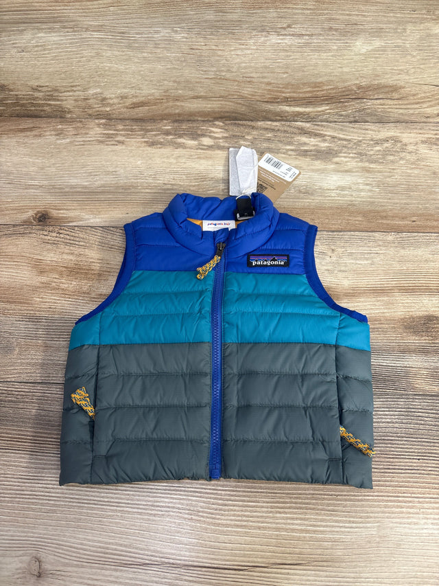 Patagonia kids' sleeveless puffer vest in blue, teal, and gray on wooden surface with zipper and logo