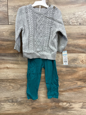 Toddler 2-piece outfit with gray cable-knit sweater and teal leggings on wooden floor