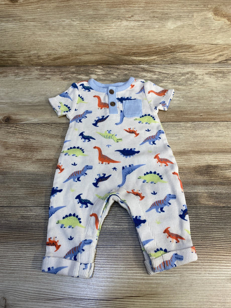 Colorful dinosaur print baby romper on wood background, short sleeves, front buttons, pocket.