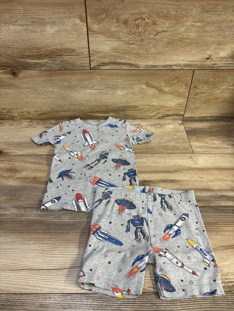 Flat lay of Member’s Mark 2-piece grey toddler pajama set (4T) showing rockets, robots, and UFOs on wood background