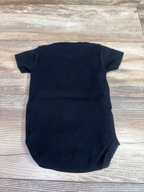 Back view of Creative Knitwear Golden Knights black bodysuit in size 0 to 3 months on a wood grain surface