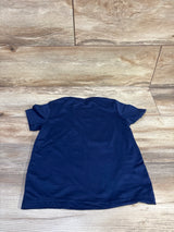 Back view of navy toddler t-shirt (size 4-5T) showing plain back and short sleeves on wood floor background