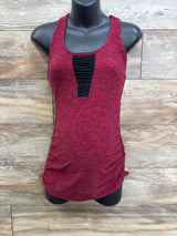 Front of maternity racerback tank in spacedye red with black ruched inset and side ruching on wood background