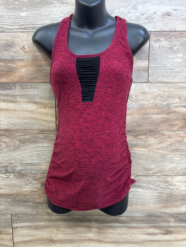 Front of maternity racerback tank in spacedye red with black ruched inset and side ruching on wood background