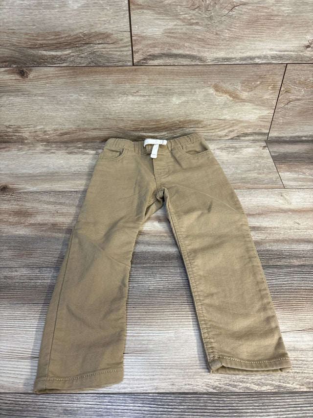 Kids khaki pants with white drawstring, laid on wooden floor