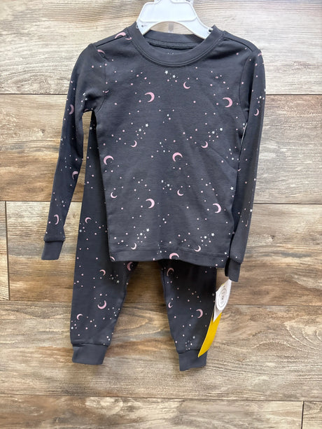 Front view of Petit Lem grey two-piece pajama set with long sleeves and pink moon and star print on wood background