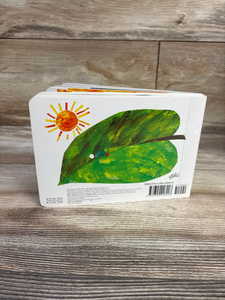 Back cover of The Very Hungry Caterpillar board book showing a caterpillar on a green leaf beneath a sun on a wood surface