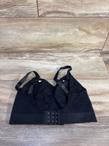 Top-down view of black nursing bra with adjustable straps and nursing clips, showing three-row hook-and-eye back on wood floor background