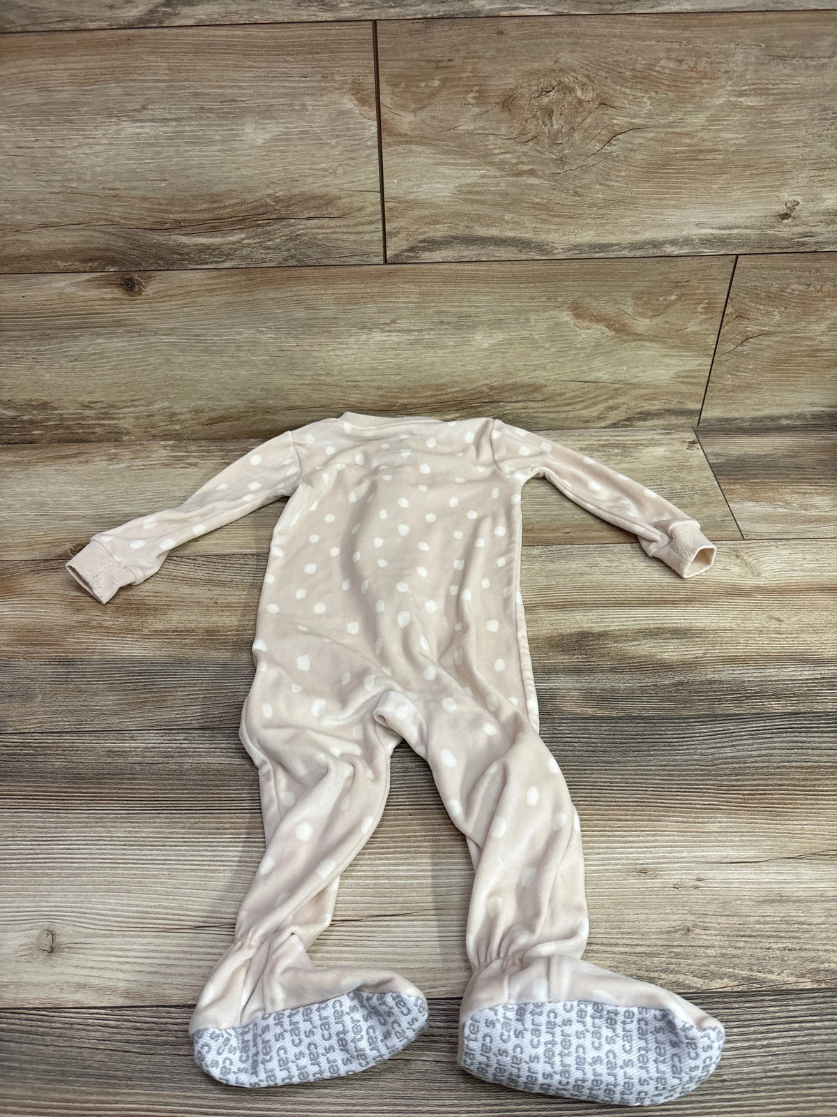 Front view of Carter’s tan blanket sleeper showcasing white dots and enclosed grippy feet on wood flooring, size 12 months