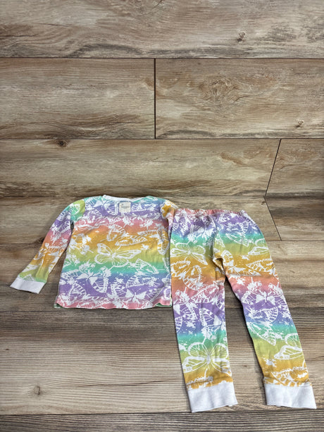 Children's two-piece pajama set with multicolor rainbow background and white butterfly print on wooden floor