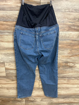 Back of Isabel Maternity 90s straight jeans showing black over-belly panel and blue denim on hanger against wood background