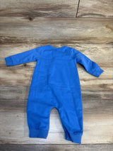 Blue long sleeve baby romper displayed on wooden background