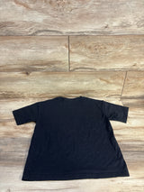 Black kids t-shirt laid flat on wood floor, children's clothing resale