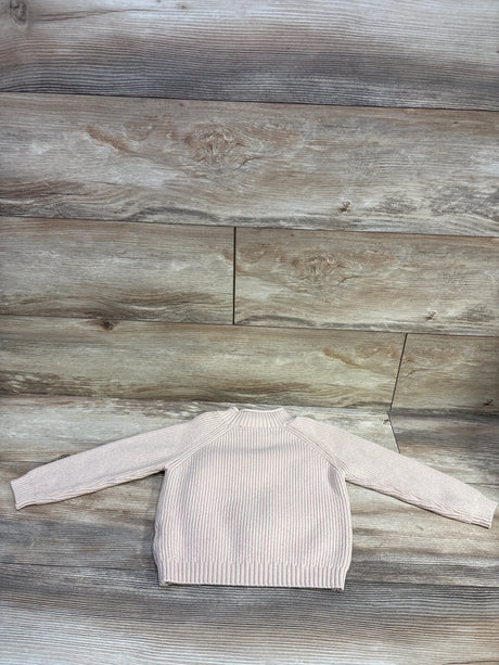 Front view of Shein knit sweater in beige, size 2 to 3T, showcasing ribbed texture and long sleeves on a wood look floor