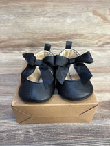 Black baby Mary Jane shoes with bows, soft sole for infants, displayed on box
