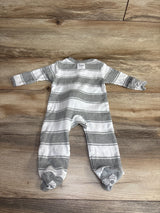 Gray and white striped baby footed sleeper from Burt's Bees on wood surface