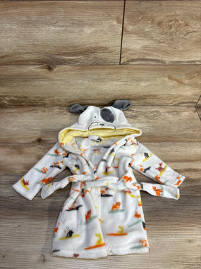 Flat lay of white baby plush robe showing dog-print pattern, hood with embroidered dog face and gray ears, and tie belt on wood background