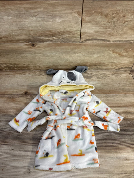 Flat lay of white baby plush robe showing dog-print pattern, hood with embroidered dog face and gray ears, and tie belt on wood background