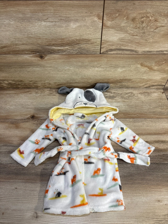 Flat lay of white baby plush robe showing dog-print pattern, hood with embroidered dog face and gray ears, and tie belt on wood background