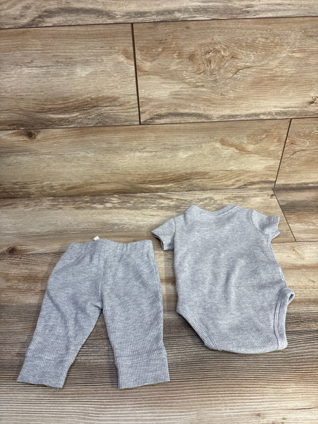 Top-down view of grey Carter's 2-piece waffle knit bodysuit and pants set laid flat showing ribbed texture on wooden floor