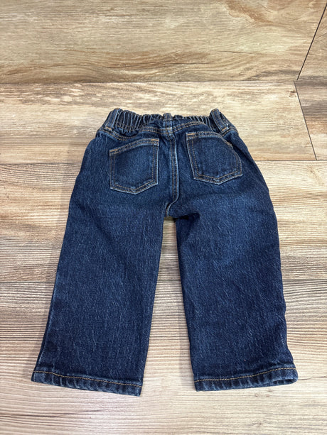 Navy blue Old Navy baby jeans for size 6-12m on a light wood floor.