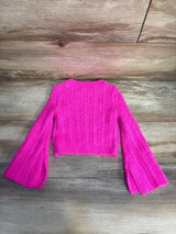 Bright pink ribbed knit long sleeve sweater for kids on wooden background