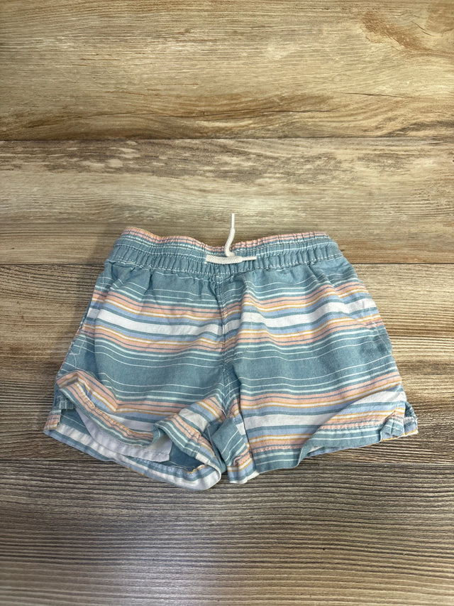 Front view of OshKosh boys' blue striped cotton shorts with elastic waistband and white drawstring on wood background
