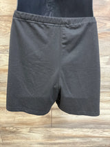 Top view of Ekouaer maternity lounge shorts in black showcasing an elastic waistband on a wood-patterned background