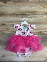 Flat lay of pink Disney Minnie Mouse tutu bodysuit showing layered tulle skirt, flutter sleeves, and snaps on wood background
