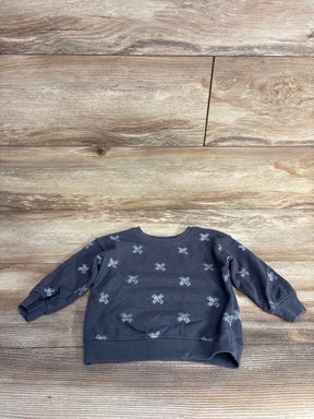 Gray long sleeve toddler sweatshirt with silver star patterns on wooden background